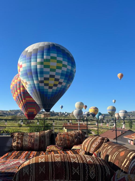 a bunch of hot air balloons flying in the sky at Balloon Street Cappadocia in Göreme
