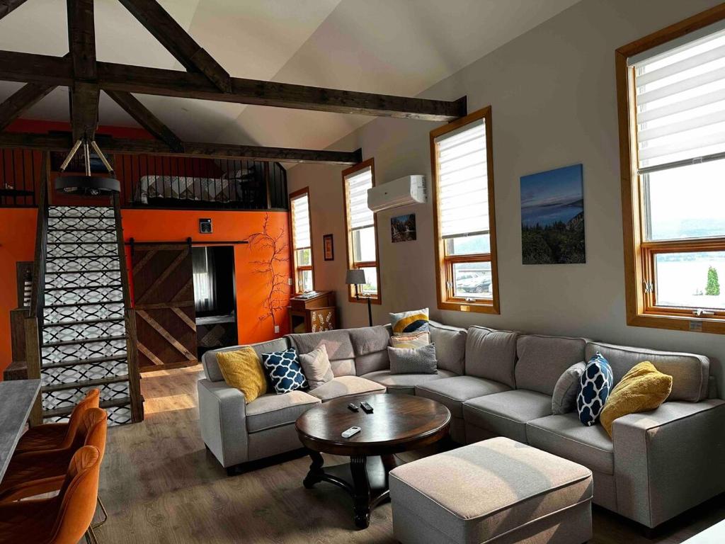 a living room with a couch and a table at A Stay Across The Bay in Curling