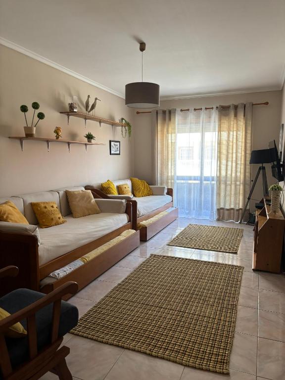 a living room with a couch and a table at Brisa do Mar in Vagos
