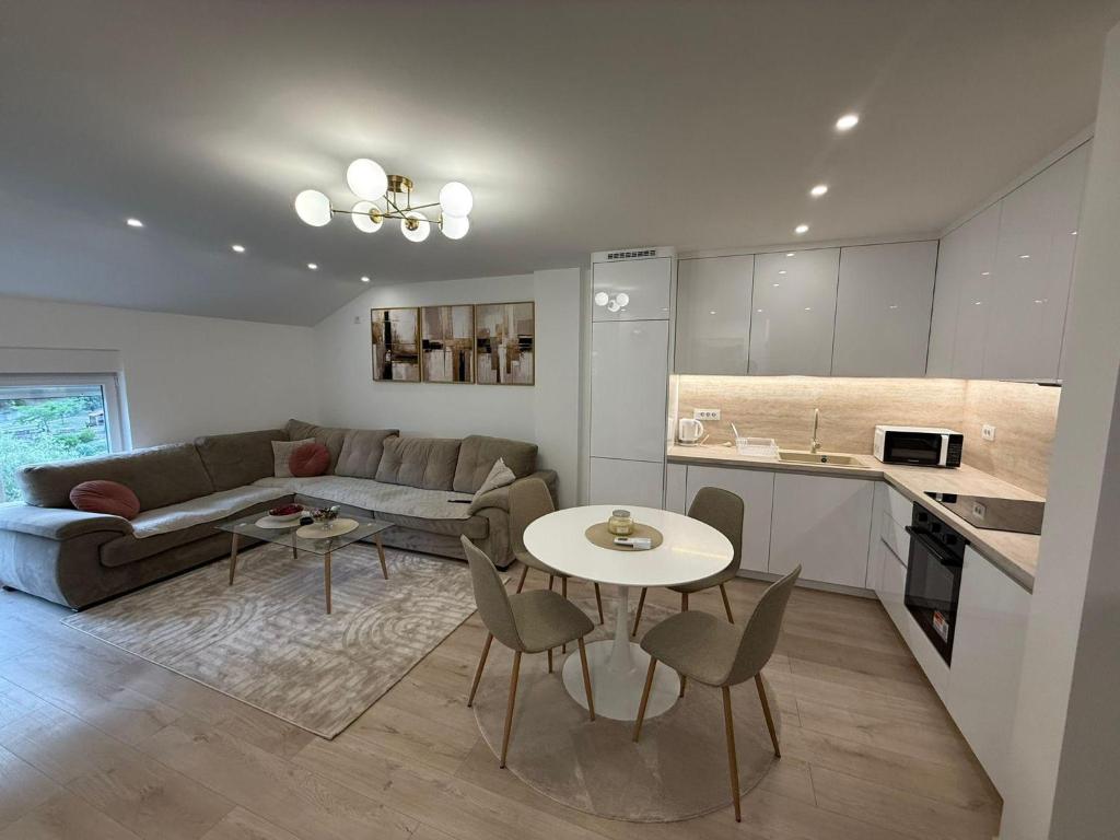 a living room with a couch and a table at Meddy Luxury Apartment in Mostar
