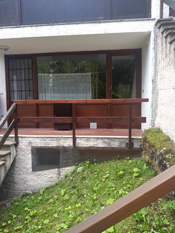 a wooden bench sitting on the side of a building at margue residence meledrio in Folgarida
