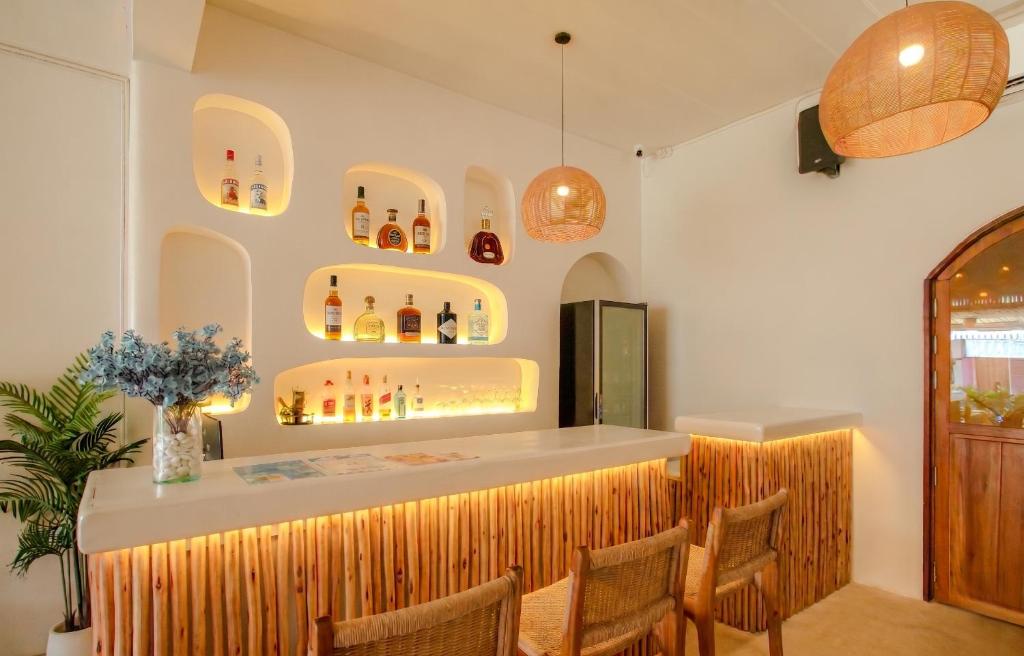 a bar in a restaurant with chairs and a counter at Hi Sea Hostel - Boutique Style in Center, 15 min Walk from Pier in Thong Sala
