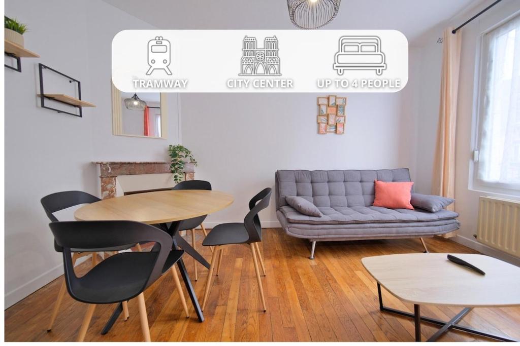 a living room with a couch and a table and chairs at Margherita in Reims