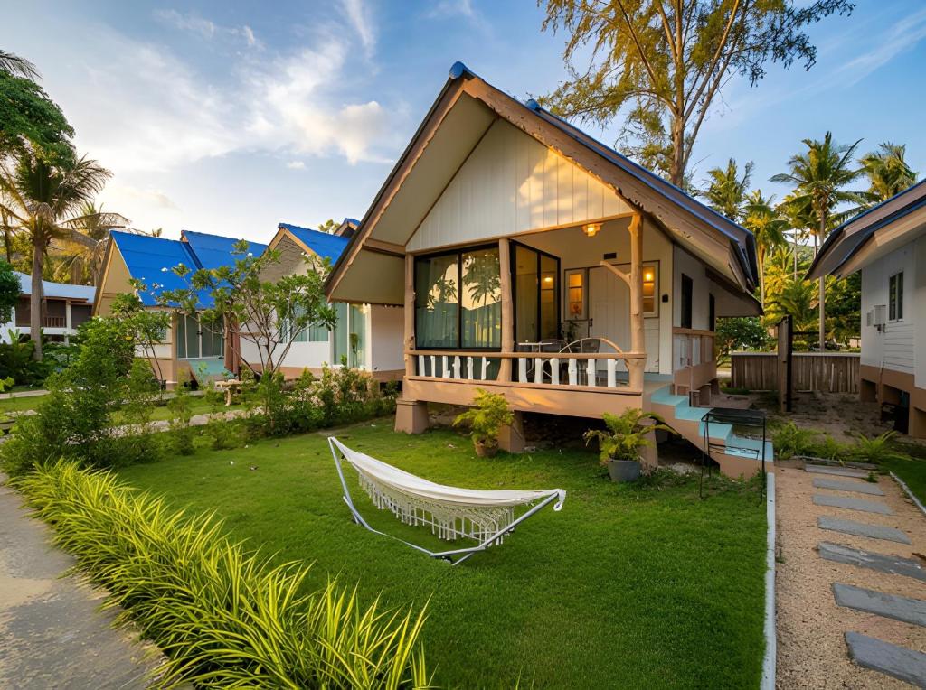 a house with a hammock in the yard at Nirvana By the Sea in Ban Madua Wan