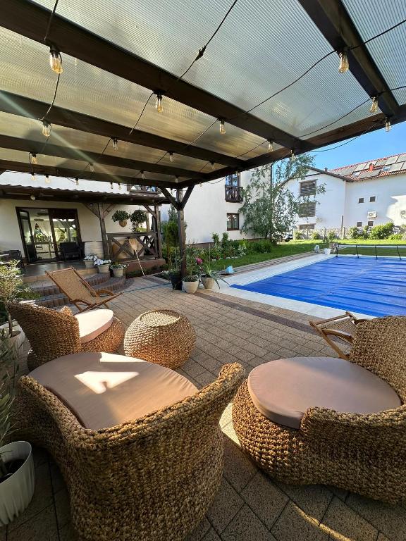 a patio with a table and chairs and a pool at Rodart Morski in Sztutowo