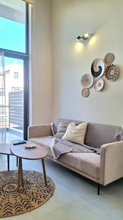 a living room with a couch and a table at Dris Loft in Nikiana