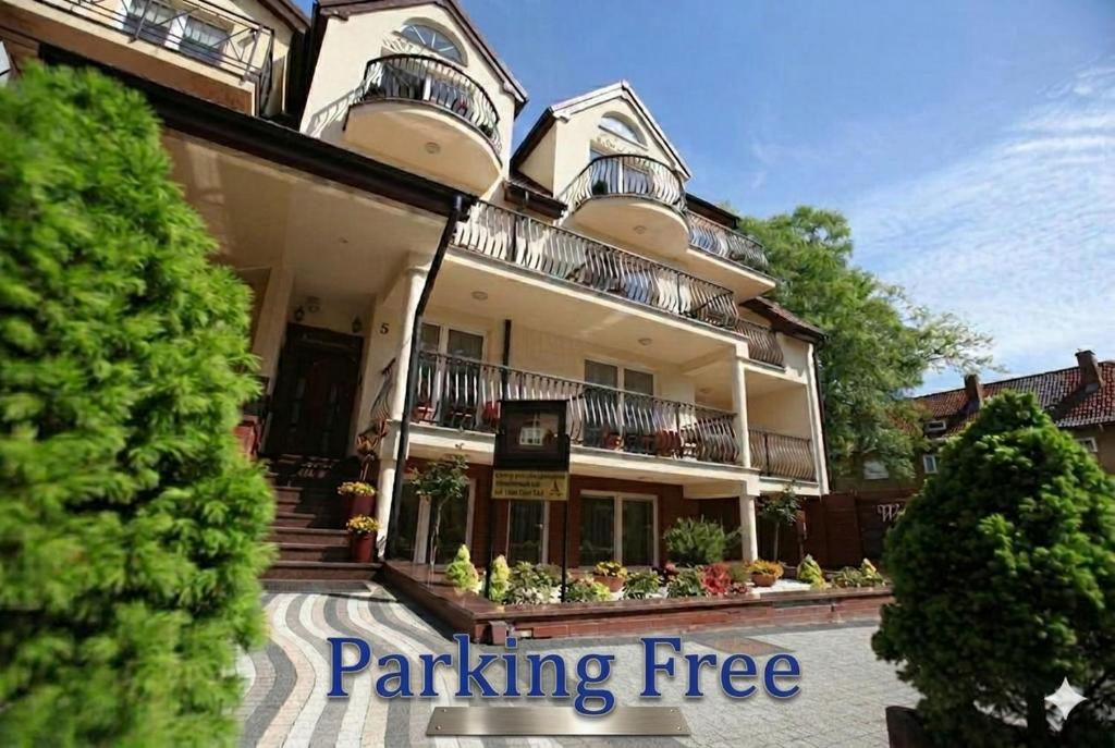 a building with a parking free sign in front of it at Willa Atena in Świnoujście