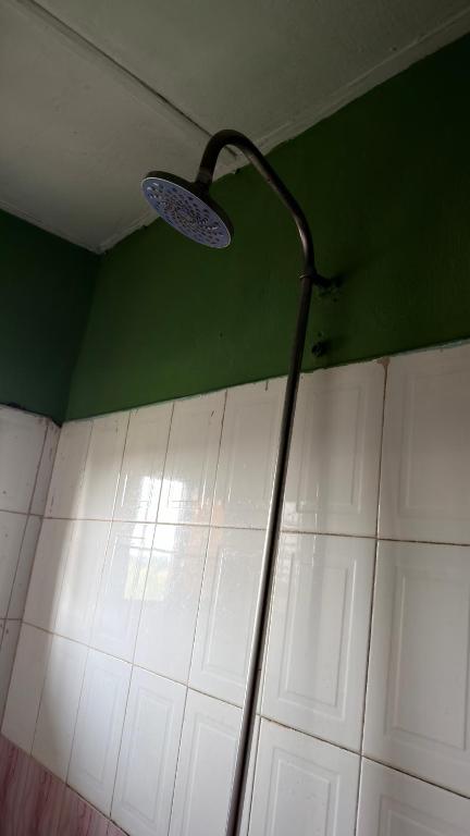 a light on a wall in a room at Best White House Hotel in Umunede
