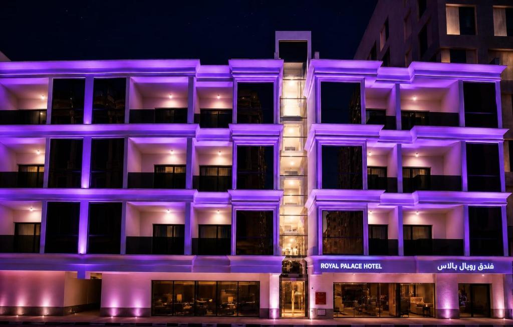 a building lit up in purple at night at Royal Palace Hotel - Al Olaya in Riyadh