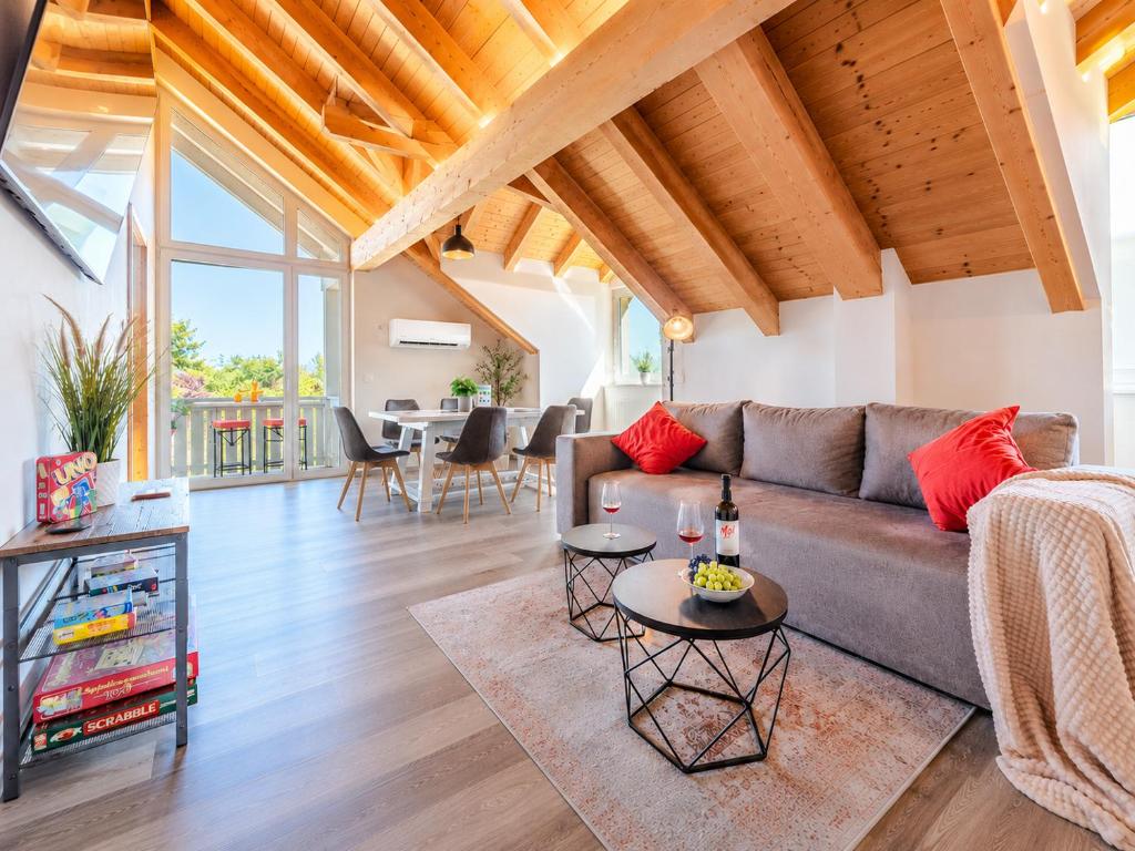 a living room with a couch and a table at Bright Lake View Apartment with Balcony and Air Conditioning in Tutzing