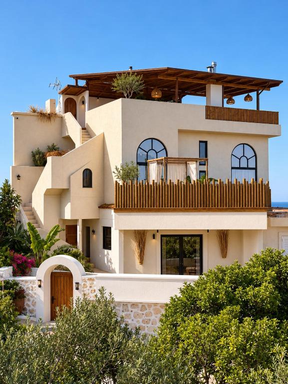 a large white house with trees in front of it at Casa Boha in Dhërmi