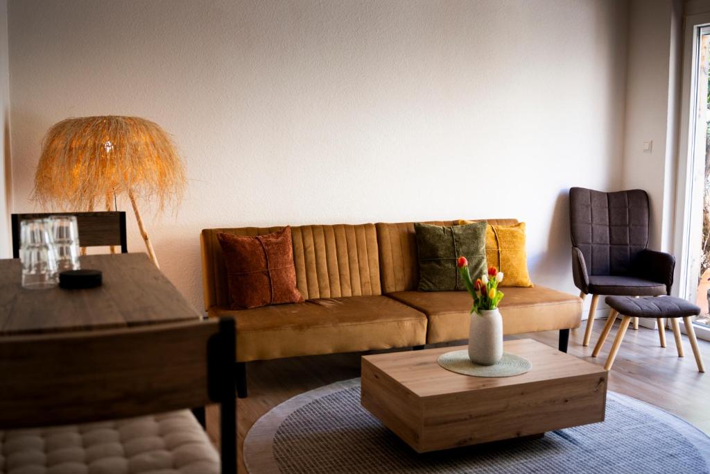 a living room with a couch and a table at Anna's Landhaus in Soltau