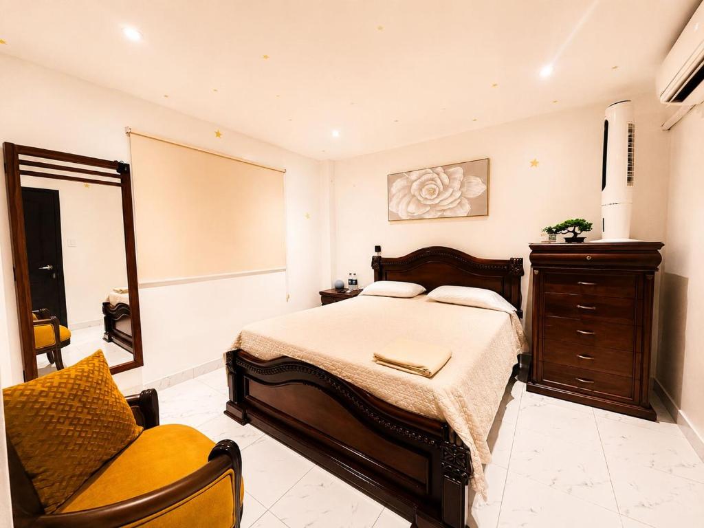 a bedroom with a bed and a chair in it at Sweet Home in San Guillermo