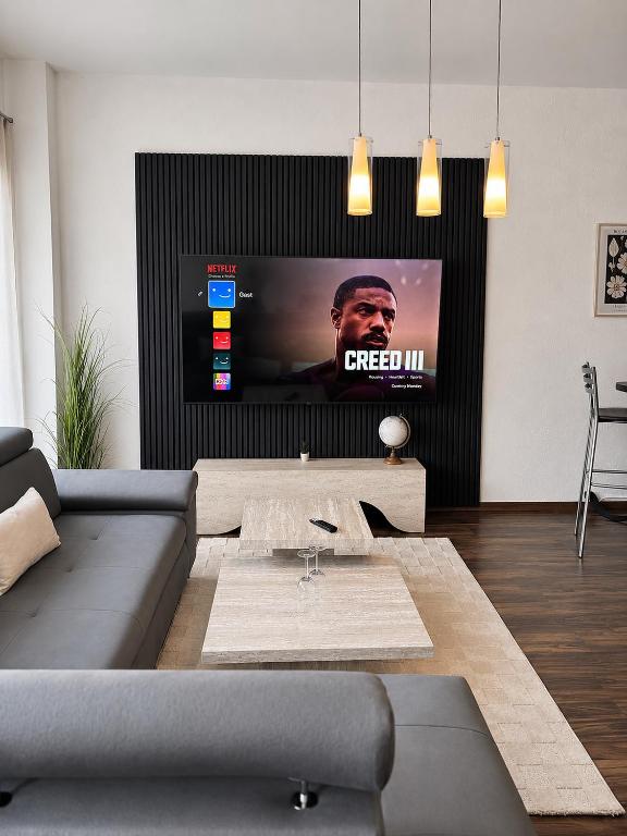 a living room with a couch and a flat screen tv at City Loft Traum Quartier Apartments in Siegen