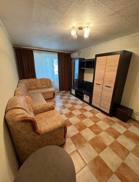 a living room with a couch and a television at Odesa Krasna, 8 Apart in Odesa