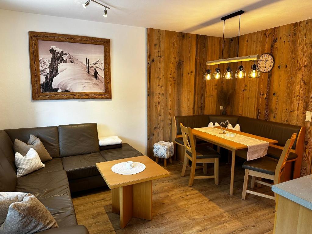 a living room with a couch and a table at Appartements Romantika & Appartement Barbara in Wagrain