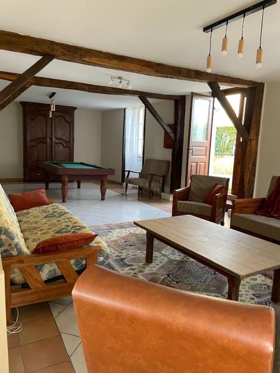 a living room with a couch and a table at BOISSET, Grande maison familiale avec vue sur les Pyrénées in Castel-Sarrazin