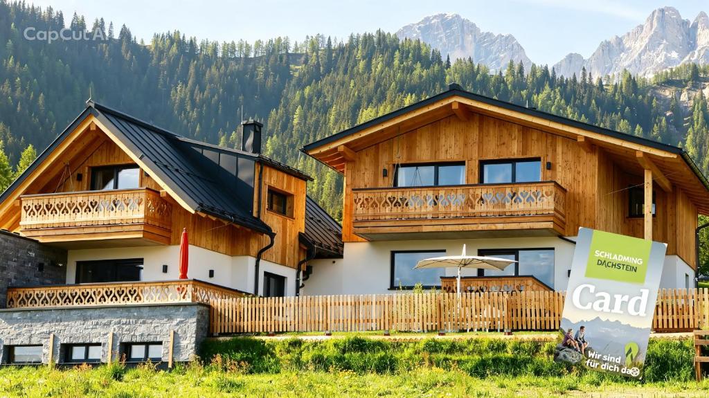 a large wooden house with a balcony at das korda - Ferienhaus & Sommercard in Ramsau am Dachstein