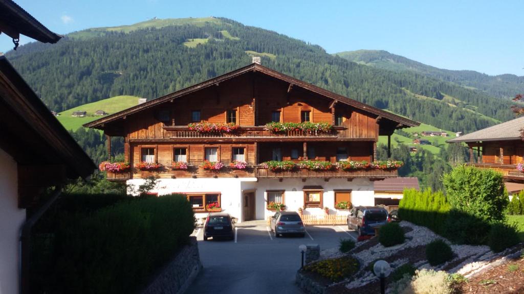 a large building with cars parked in front of it at Appartement Moaeben - Panorama in Alpbach