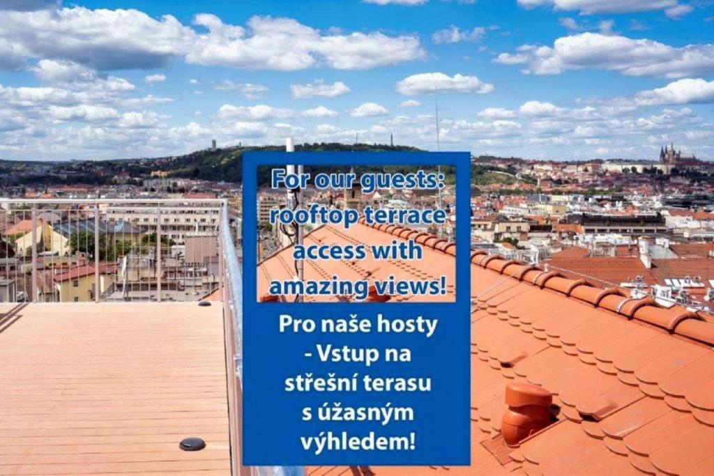 a sign on a roof with a view of a city at EA Hotel Moment Self Check-In in Prague