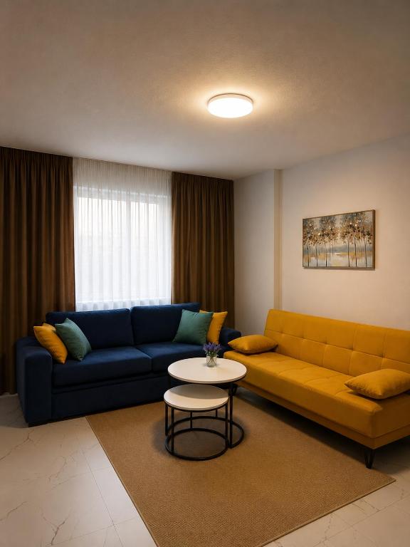 a living room with a couch and a table at Kron apartment in Shëngjin