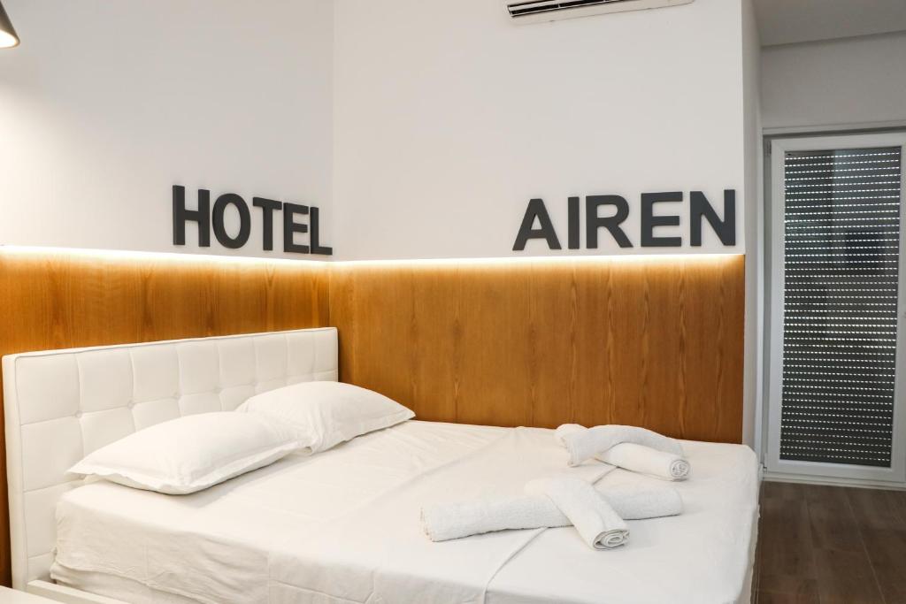 a white bed with two towels on top of it at Airen Hotel Velipoje in Velipojë