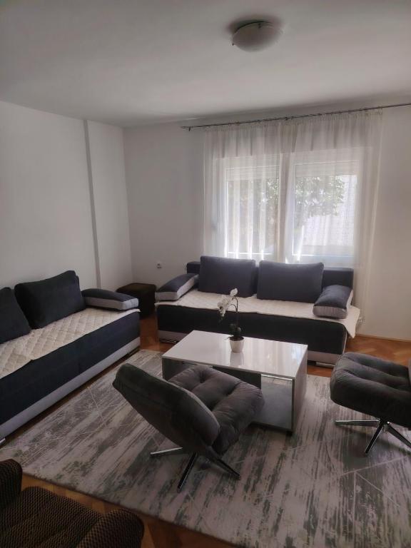 a living room with a couch and a table at Sladjana apartman in Prijepolje