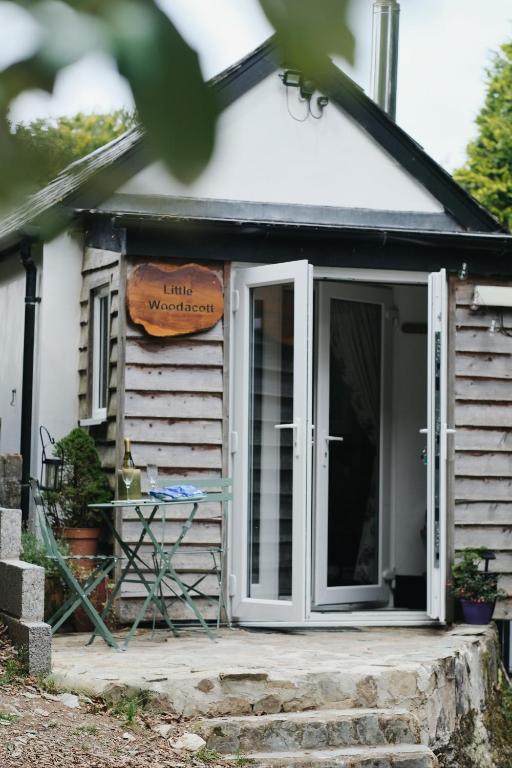 a front door of a small white house at Little Woodacott in Barnstaple