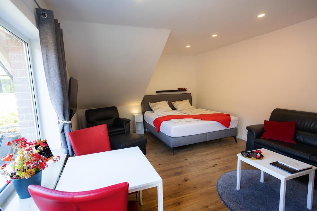 a small room with a bed and a couch at Reload Apartments - FeWo2 im Remmeker Feld in Bad Arolsen