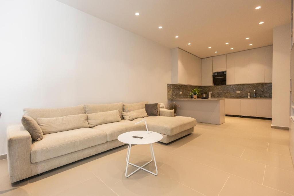 a living room with a couch and a table at Aria apartment 2 in Dhërmi