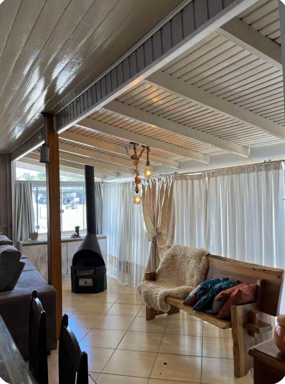 a living room with a couch and a fireplace at Incantare in São Joaquim