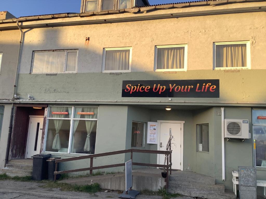 a building with a sign that reads spice up your life at Ahmad sweet home in Vardø