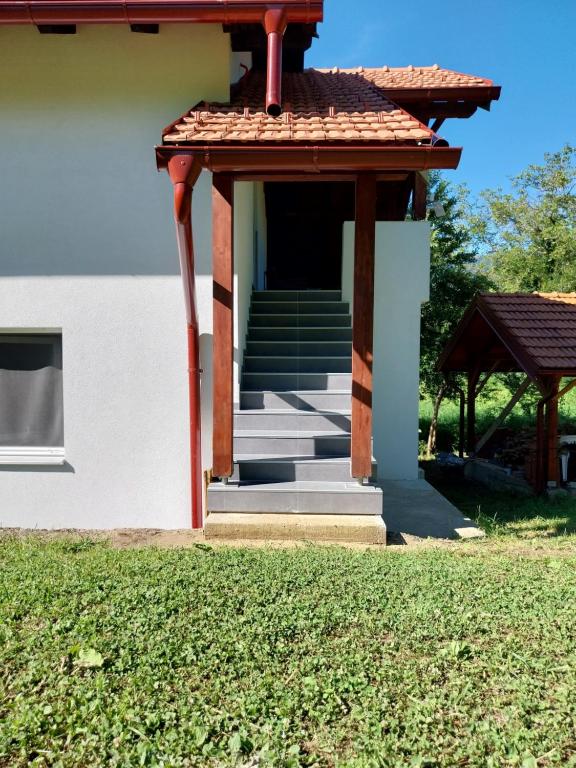 a white house with stairs and a gazebo at Apartmani Lohovo 2 in Lohovo