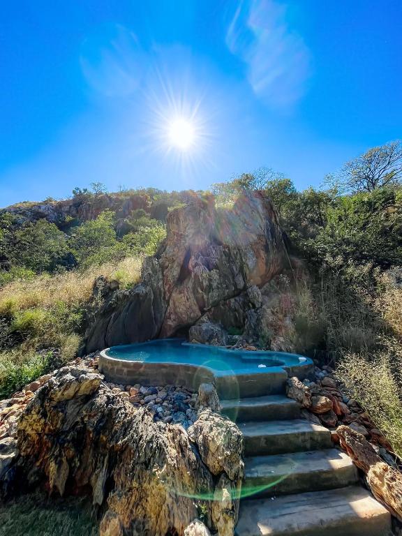 a set of stairs leading to a swimming pool on a mountain at Glocke Mountain Camp in Outjo