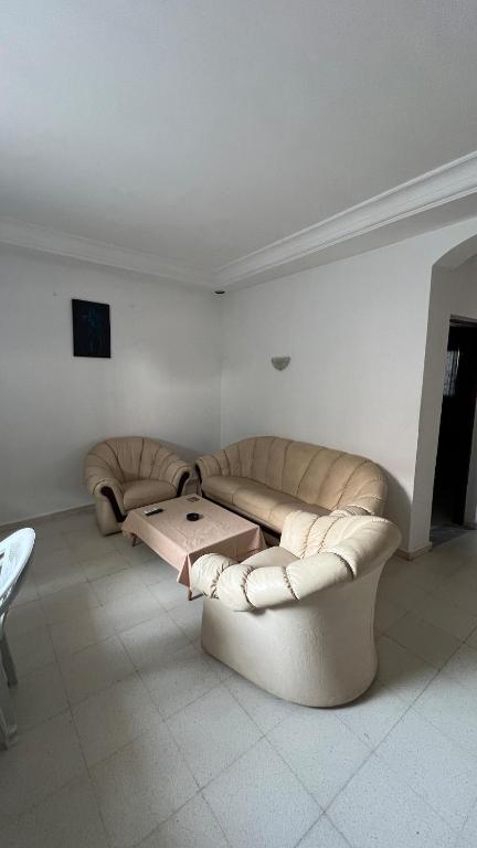 a living room with a couch and a table at House in Djerba s1 in Midoun