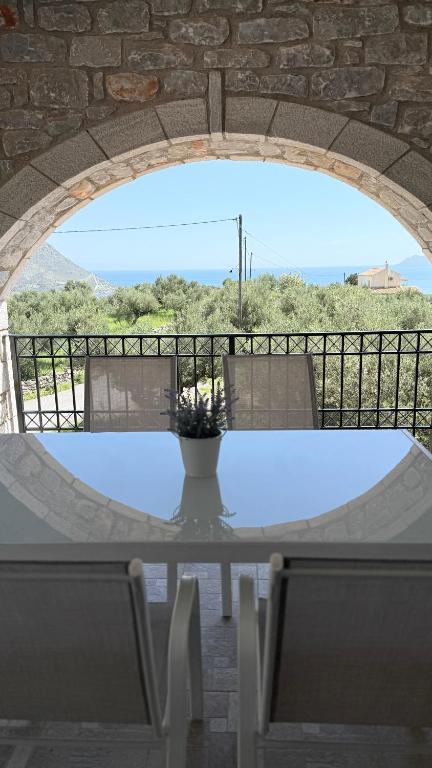 a table with a vase on top of it at Casa SanGiorgio Stone Villas with Sea View in Skaltsotiánika