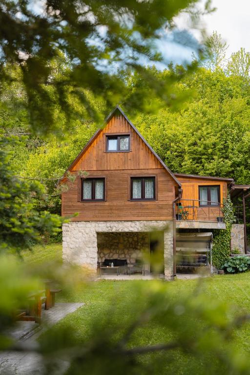 a large wooden house in the middle of a yard at Chata Jánošík in Terchová