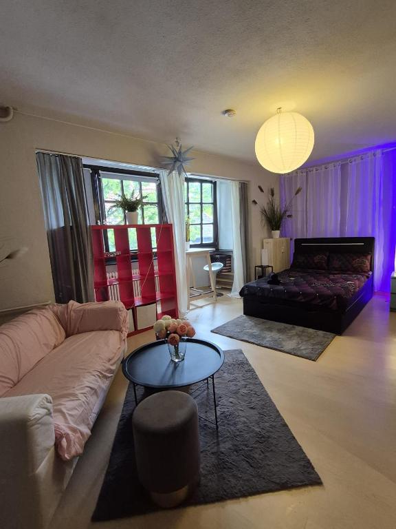 a living room with a couch and a table at Modern & Quiet City Apartment in Hannover