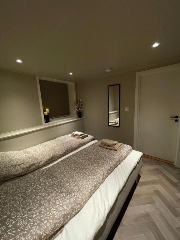 a bedroom with a bed with two towels on it at Halden downtown apartment in Halden