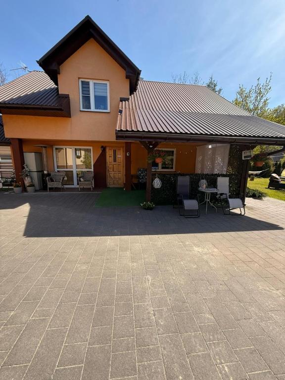 a house with a roof and a patio at Sosnowe Zacisze in Zwierzyniec
