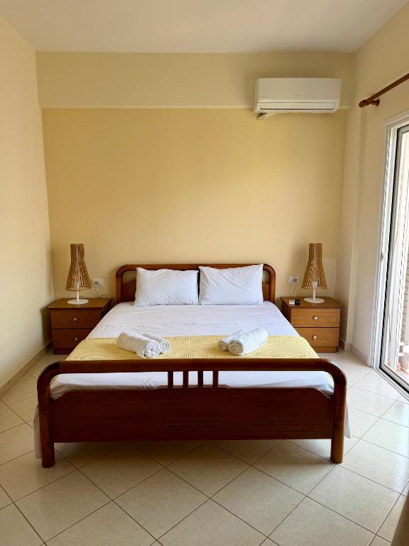 a bedroom with a bed with two towels on it at Mihasi Apartments in Ksamil