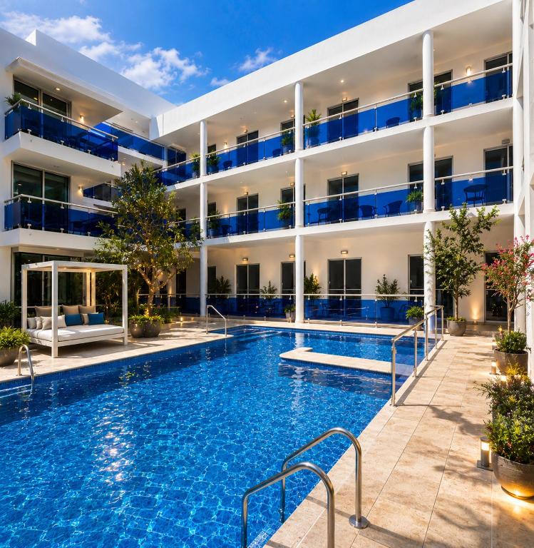 a swimming pool in front of a building at Modern Tropical Oasis in Sosúa