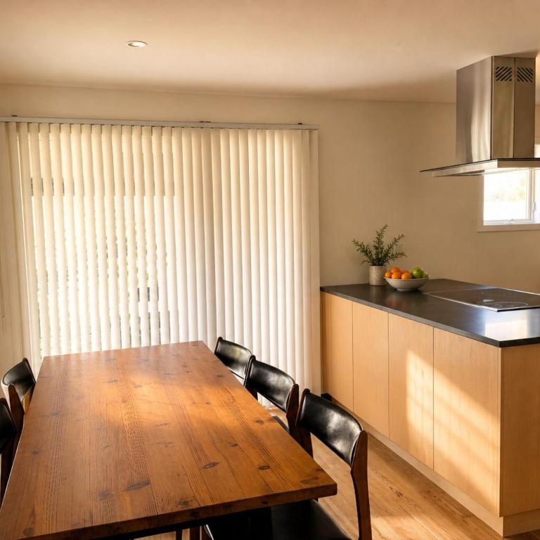 a kitchen with a wooden table and some chairs at VAIL MOUNTAIN SUITE in Vail