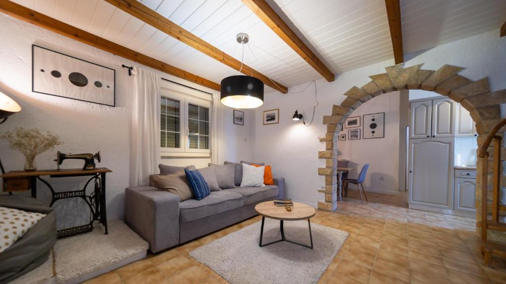 a living room with a couch and a table at Beach Suite Nina in Rab