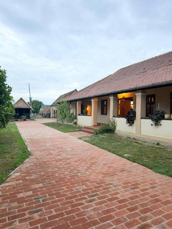 a brick road in front of a building at Rusticca M- slavonska kuća in Rokovci