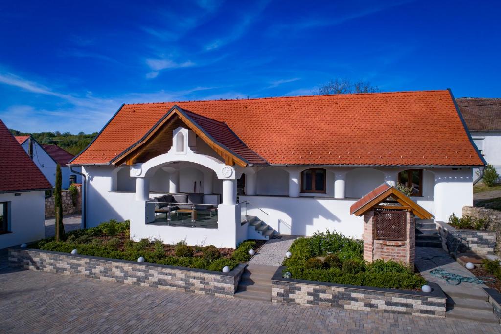 a house with an orange roof at Veloralux Apartman in Kovácsszénája