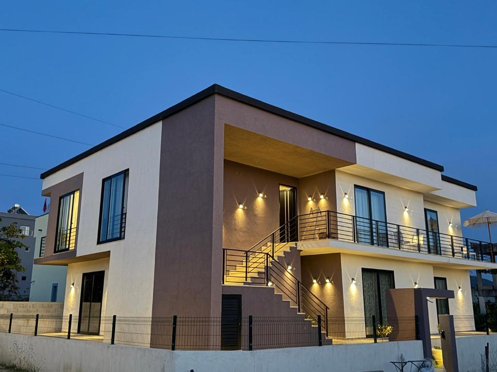 a large house with stairs in front of it at SD House in Vlorë