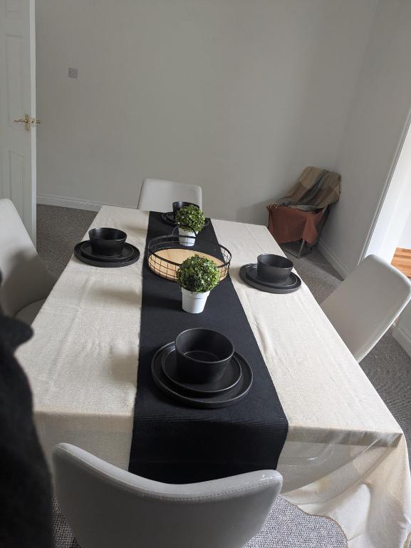 a table with a black and white table cloth at Grange Retreat in Pontnewydd