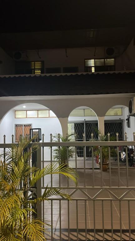 a building with two arches and a fence at Impian Melaka Homestay in Malacca