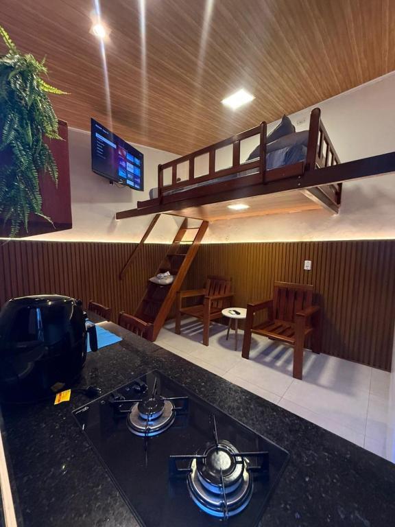 a living room with a bunk bed and a kitchen at Condomínio Feitosa Barros I in Maceió